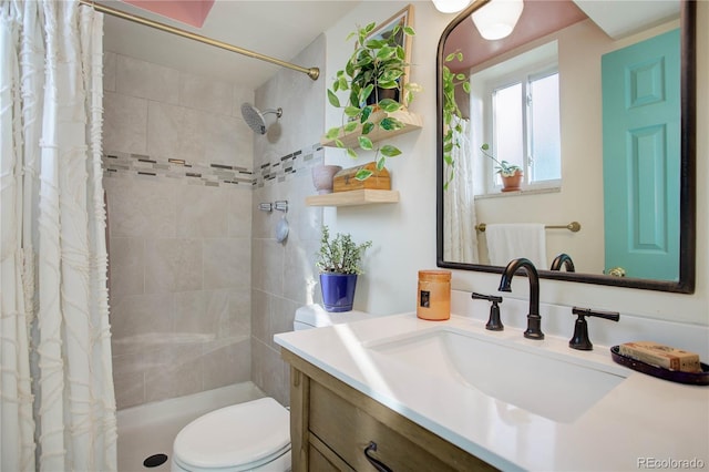 bathroom with a shower with curtain, vanity, and toilet