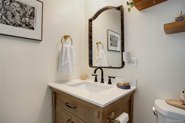 bathroom with toilet and vanity