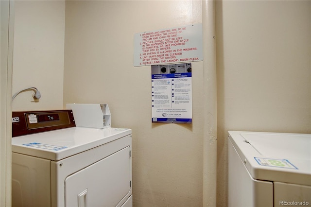 community laundry room with washing machine and clothes dryer