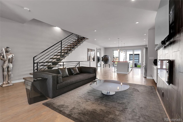4156 Vrain St, Denver, CO 80212 - living area featuring light wood-type flooring, stairs, recessed lighting, and washer / clothes dryer