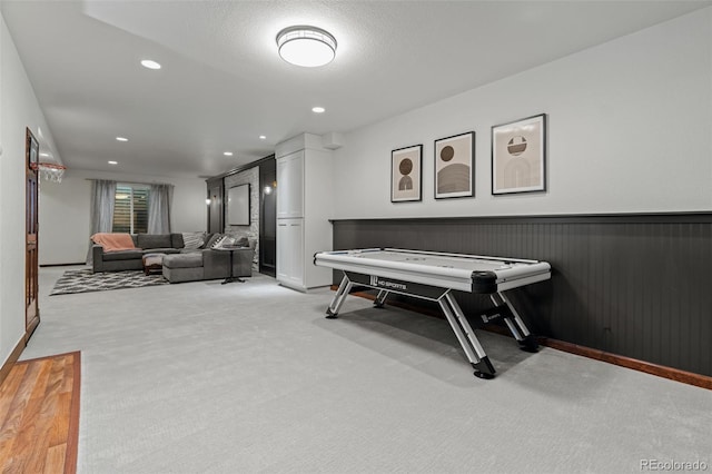 rec room with light carpet, a wainscoted wall, recessed lighting, and baseboards