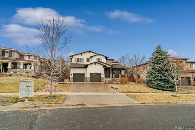 view of front facade with a garage, driveway, and stone siding