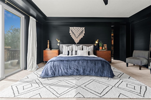 carpeted bedroom featuring crown molding and access to outside