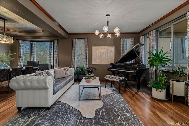 living room with wood finished floors, a chandelier, and ornamental molding