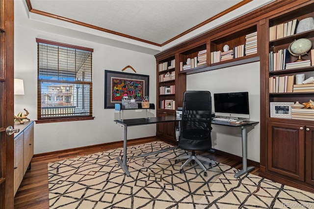 office space featuring wood finished floors, baseboards, and crown molding