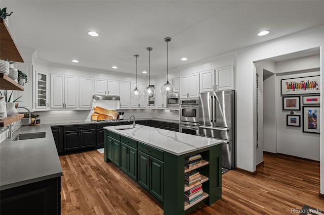 kitchen featuring open shelves, appliances with stainless steel finishes, green cabinets, under cabinet range hood, and recessed lighting