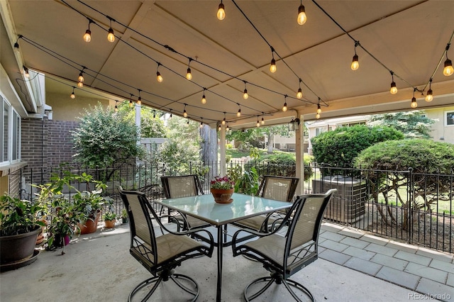 view of patio featuring outdoor dining space and fence