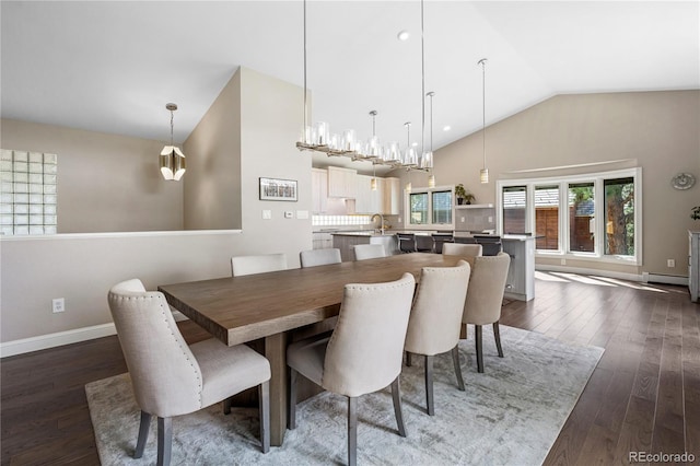 dining space with dark wood-style flooring, a baseboard radiator, baseboards, and high vaulted ceiling