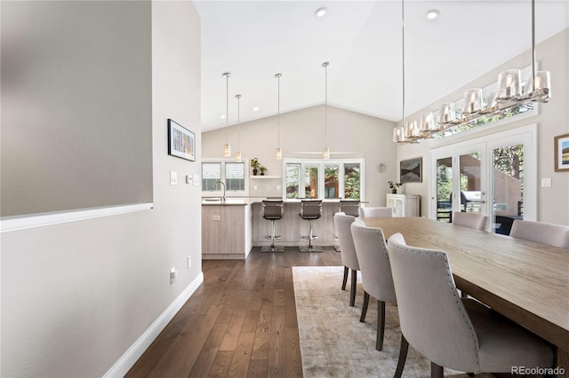dining area featuring baseboards, dark wood finished floors, healthy amount of natural light, high vaulted ceiling, and french doors