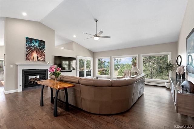 living area featuring a ceiling fan, vaulted ceiling, baseboard heating, a multi sided fireplace, and dark wood-style floors