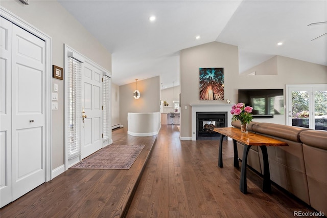 reception area featuring lofted ceiling, a glass covered fireplace, and recessed lighting