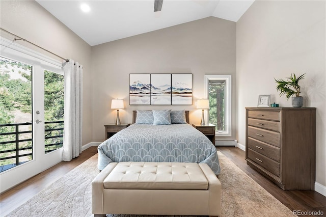 bedroom featuring access to exterior, multiple windows, wood finished floors, a baseboard heating unit, and high vaulted ceiling