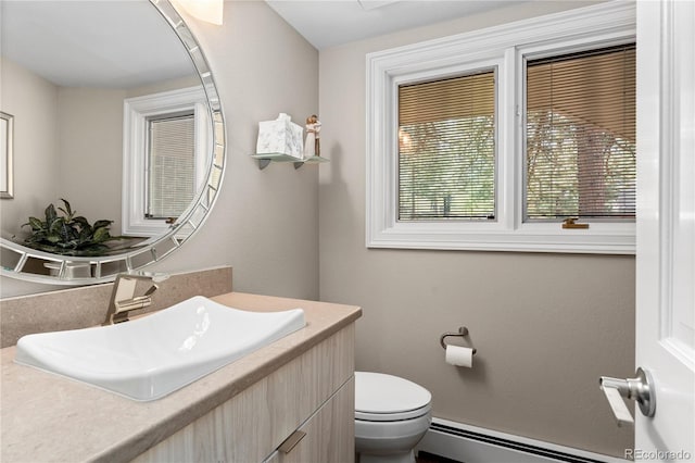 bathroom featuring a baseboard radiator, vanity, and toilet