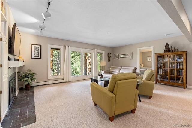 living room featuring a baseboard radiator, a fireplace with flush hearth, stone finish flooring, and baseboards