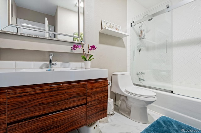 full bathroom with toilet, marble look tiles, shower / bath combination with glass door, and vanity