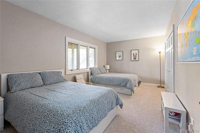 bedroom with carpet flooring and baseboards