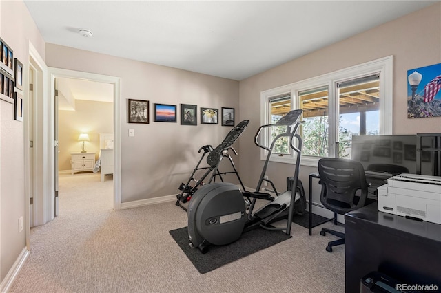 workout room featuring carpet floors and baseboards