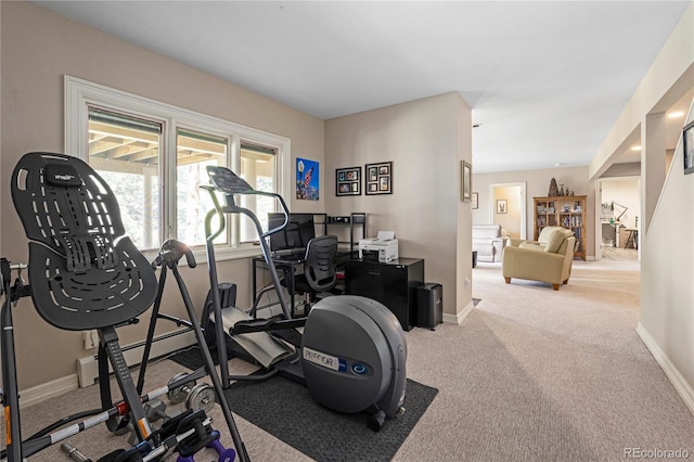 workout area with baseboards, carpet floors, and a baseboard radiator
