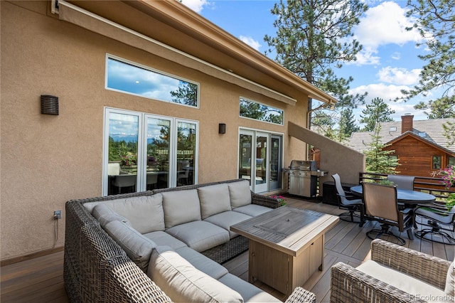 deck featuring an outdoor living space, outdoor dining area, and grilling area