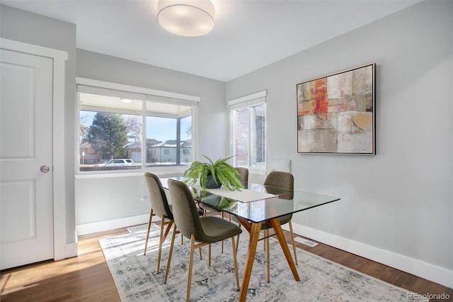 dining space featuring hardwood / wood-style floors and plenty of natural light