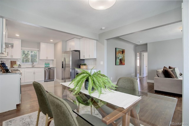 dining space with sink and dark hardwood / wood-style floors