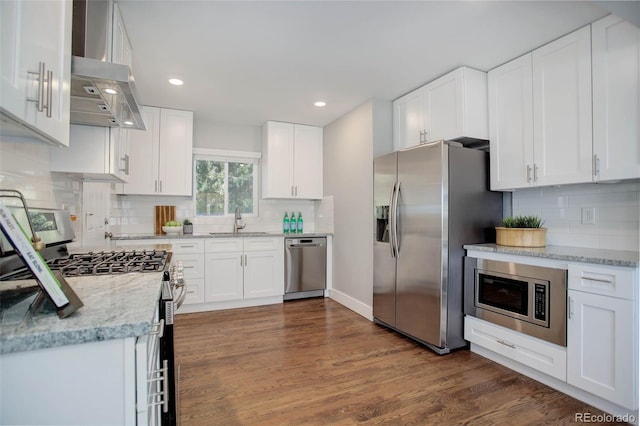 kitchen featuring white cabinetry, sink, dark wood-type flooring, stainless steel appliances, and exhaust hood