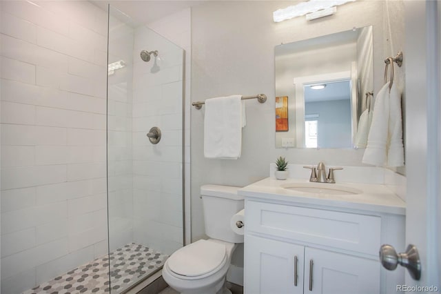 bathroom with an enclosed shower, vanity, and toilet