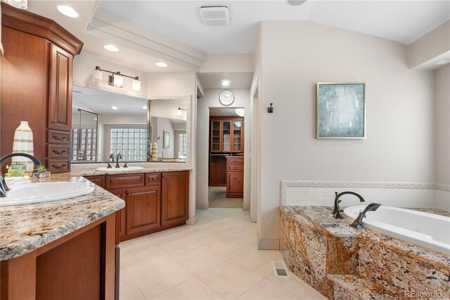 11 Canon Pl, Greenwood Village, CO 80111 - full bathroom with two vanities, a garden tub, tile patterned flooring, recessed lighting, and vaulted ceiling