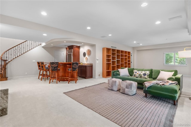 11 Canon Pl, Greenwood Village, CO 80111 - living room featuring a dry bar, recessed lighting, stairway, light carpet, and arched walkways