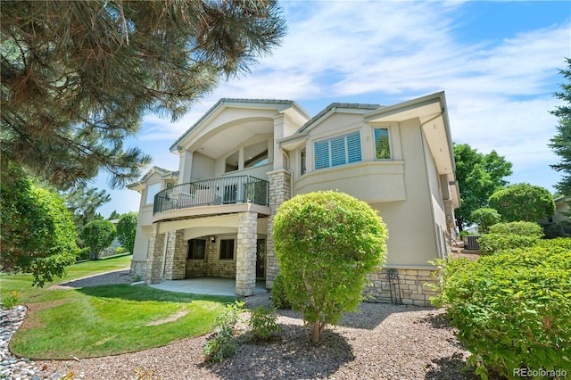 11 Canon Pl, Greenwood Village, CO 80111 - back of house featuring a balcony, a patio area, a lawn, and stucco siding