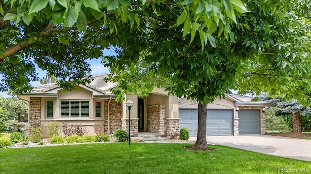 11 Canon Pl, Greenwood Village, CO 80111 - view of property hidden behind natural elements featuring a garage, driveway, stone siding, a front yard, and stucco siding