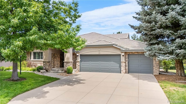 11 Canon Pl, Greenwood Village, CO 80111 - view of front of home with stone siding, a garage, concrete driveway, stucco siding, and a front lawn
