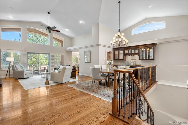 11 Canon Pl, Greenwood Village, CO 80111 - living room featuring a ceiling fan, healthy amount of natural light, wood finished floors, high vaulted ceiling, and a chandelier