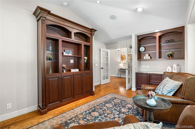 11 Canon Pl, Greenwood Village, CO 80111 - living area with vaulted ceiling, french doors, and light wood-type flooring