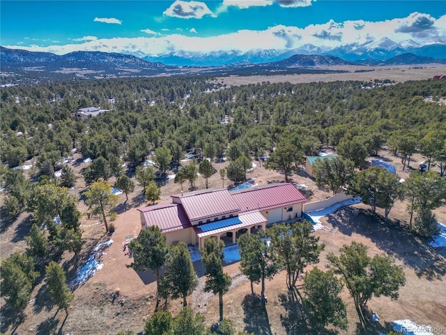 bird's eye view featuring a forest view and a mountain view