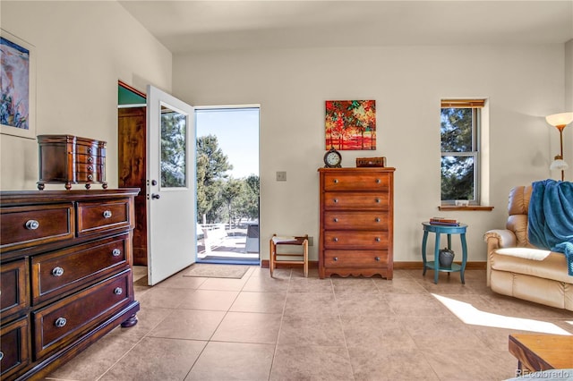 sitting room with light tile patterned flooring and baseboards