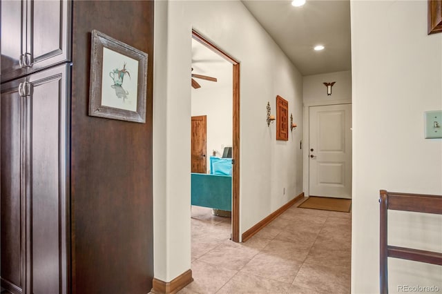 corridor with recessed lighting and baseboards