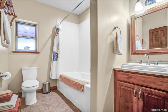 bathroom with tile patterned flooring, toilet, shower / tub combo, vanity, and baseboards