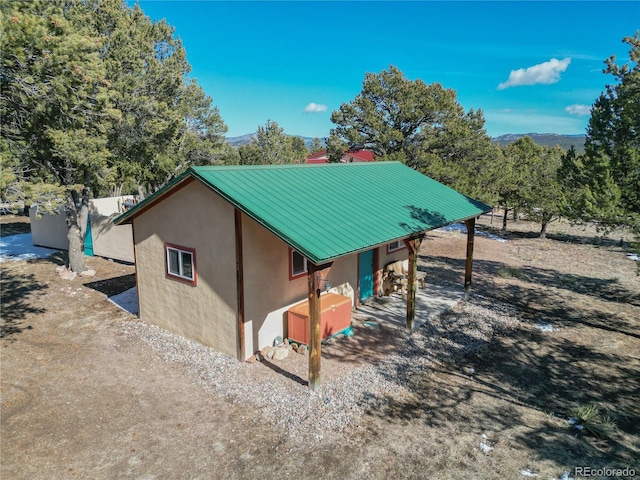 view of property exterior featuring metal roof and stucco siding