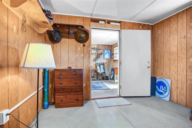 interior space featuring concrete flooring and wood walls