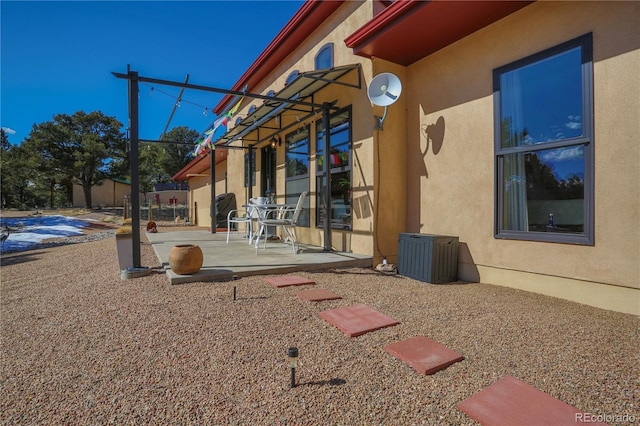 exterior space with a patio area and stucco siding