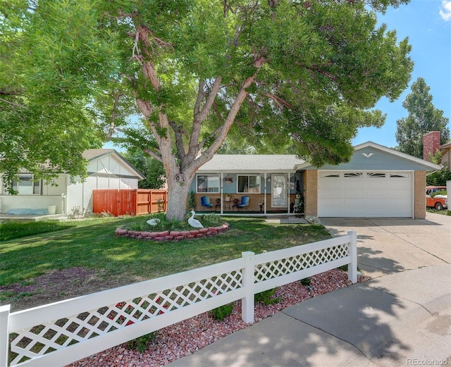 6416 Zang Ct, Arvada, CO 80004 - view of front facade featuring driveway, a fenced front yard, an attached garage, a porch, and brick siding