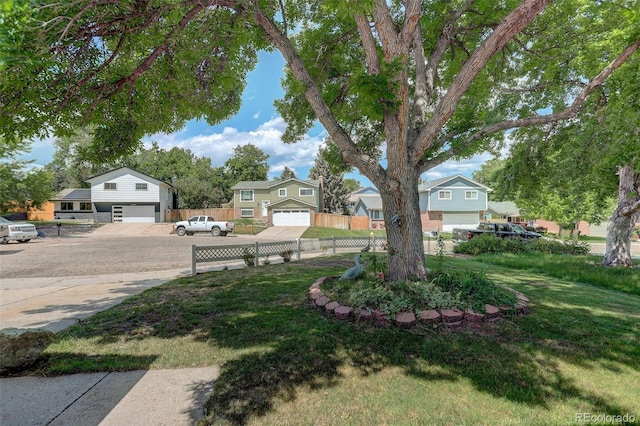 6416 Zang Ct, Arvada, CO 80004 - view of yard with an attached garage, concrete driveway, and a residential view