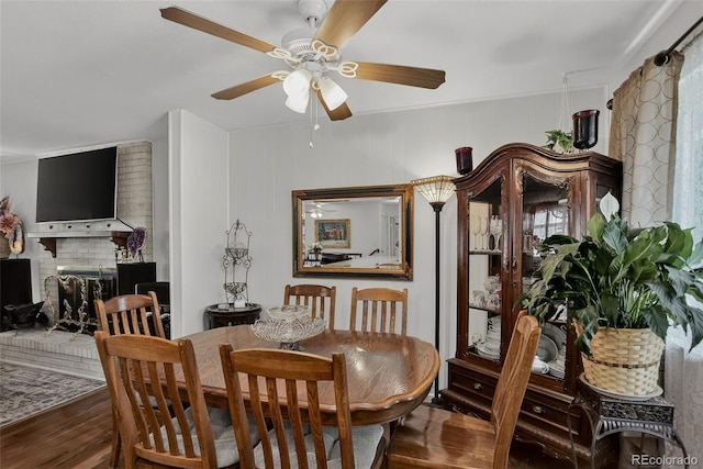 6416 Zang Ct, Arvada, CO 80004 - dining area with wood finished floors, a ceiling fan, and a fireplace