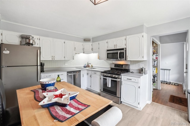 11827 Brook Rd, Golden, CO 80403 - kitchen with stainless steel appliances, a sink, white cabinetry, and light countertops