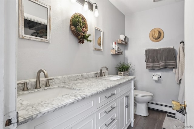 11827 Brook Rd, Golden, CO 80403 - full bath featuring a baseboard heating unit, double vanity, toilet, and wood finished floors