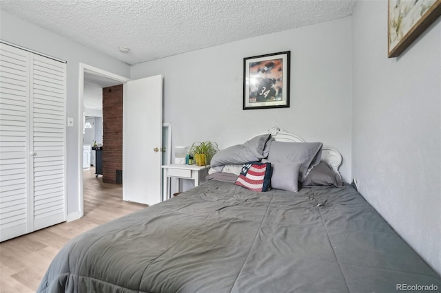 11827 Brook Rd, Golden, CO 80403 - bedroom featuring wood finished floors and a textured ceiling