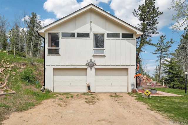 11827 Brook Rd, Golden, CO 80403 - view of front of house with dirt driveway, board and batten siding, and an attached garage