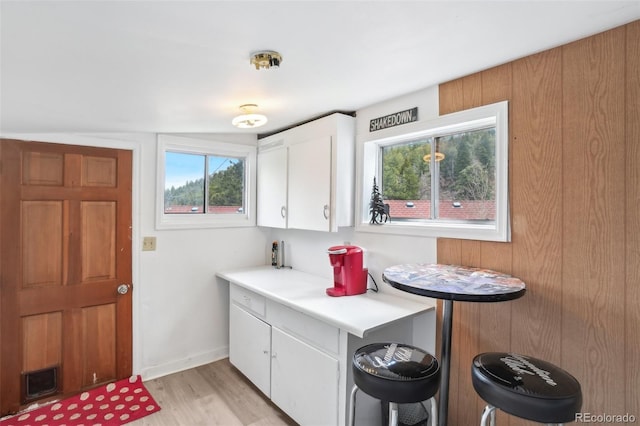 11827 Brook Rd, Golden, CO 80403 - kitchen with white cabinets, plenty of natural light, light wood-style floors, and light countertops