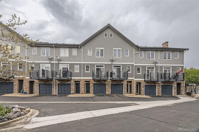 2951 W Riverwalk Cir Unit N, Littleton, CO 80123 - view of building exterior featuring a garage